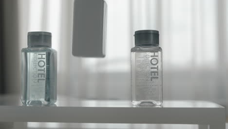 A-closeup-of-three-cosmetics-bottles-being-put-on-a-table