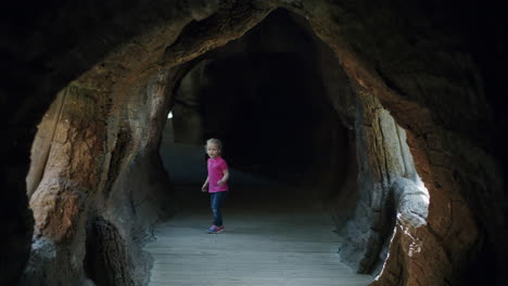 Child-running-along-the-imitated-cave