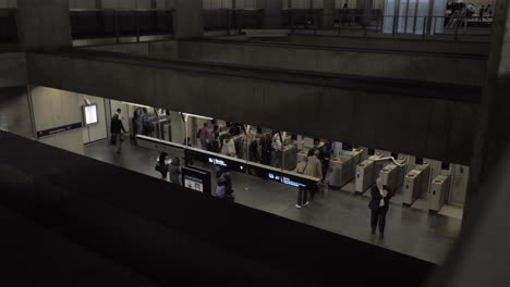 A-top-view-of-people-walking-through-automatic-turnstiles