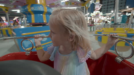 Delighted-child-in-merry-go-round-at-night