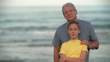 Teenager-boy-with-grandfather-by-the-sea