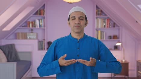 Concentrated-Muslim-man-doing-Yoga