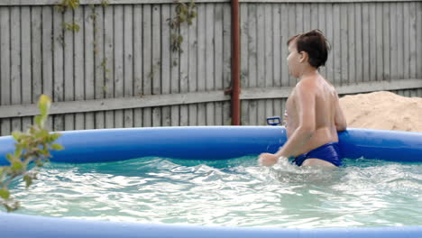Boy-swimming-in-inflatable-pool