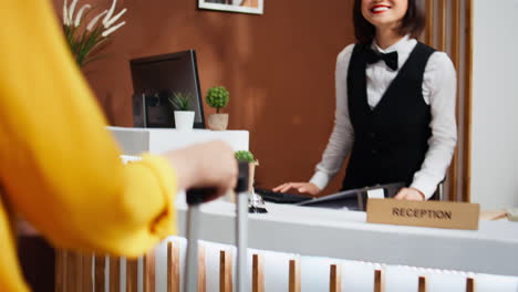 Asian-traveler-asking-receptionist-about-hotel-facilities