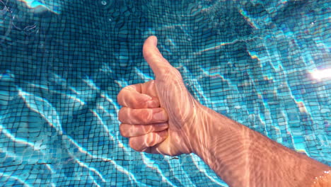 Underwater-thumbs-up-in-the-swimming-pool-cool-vacation