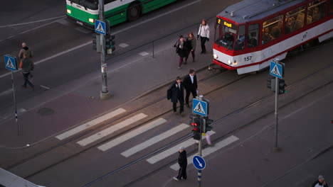 Pedestrians-crossing-the-road-on-green-light