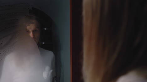 Depressed-woman-looking-in-steamy-mirror
