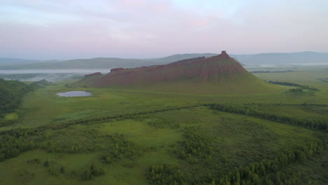 Flight-Over-Green-Steppe-to-Red-Mountain