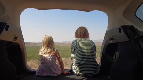 Siblings-observing-mountains-from-car-during-trip