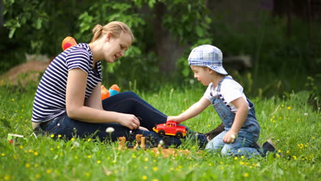 Mother-and-son-playing-outdoor-on-the-green-lawn