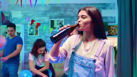 Zoom-in-shot-of-beautiful-girl-drinking-beer-from-the-bottle