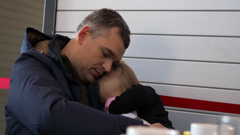 Little-girl-sleeping-in-father-hands-at-the-airport