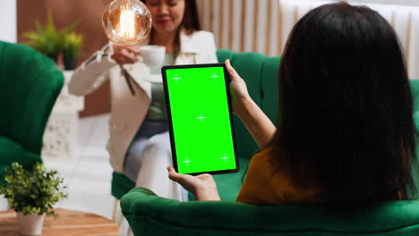 Woman-tourist-looking-at-tablet-with-greenscreen-display