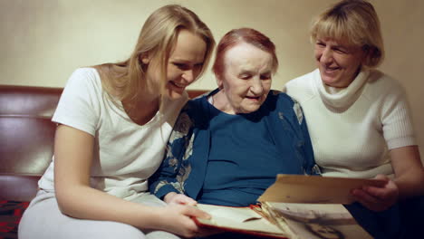 Three-women-looking-through-the-family-archive