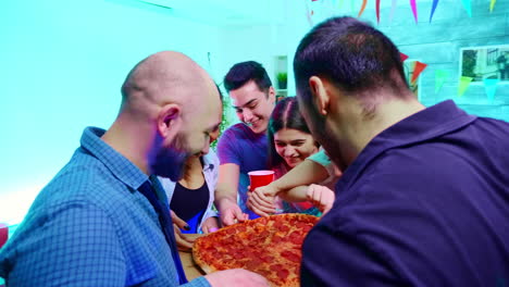 Follow-shot-of-young-man-arriving-at-the-party-with-delicious-pizza