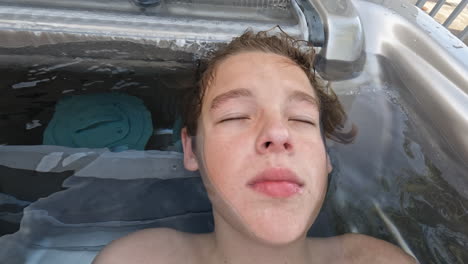 Teenager-enjoying-warm-outdoor-bath