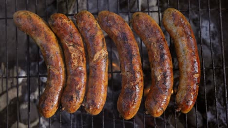 Delicious-juicy-sausages,-cooked-on-the-grill-with-a-fire.