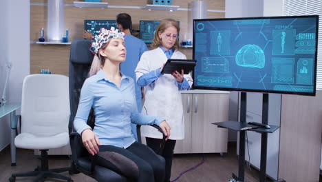 Female-patient-sitting-on-a-chair-with-brainwaves-sensors