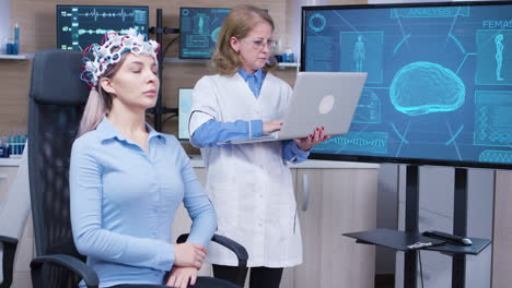 Female-doctor-in-neuroscience-checking-brain-data-on-her-laptop