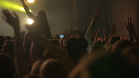 Man-Taking-Photos-of-the-Concert-on-Smartphone