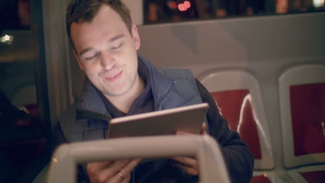 Man-with-tablet-PC-having-a-video-chat-in-the-bus