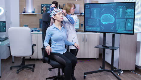 Woman-wearing-brainwave-scanning-headset-sitting-on-a-chair