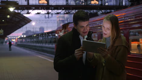 People-Using-Tablet-PC-at-Railroad-Station