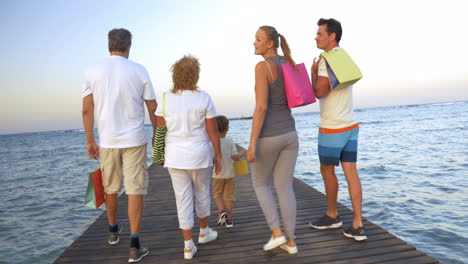 Big-family-with-shopping-bags-on-pier-in-the-sea