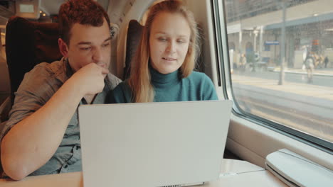 People-talk-on-business-using-laptop-in-train