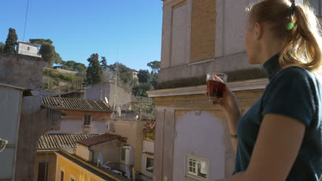 Woman-with-cup-of-tea-enjoying-view-from-the-balcony