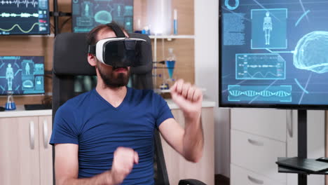 Male-scientist-sitting-on-a-chair-and-using-virtual-reality-goggles