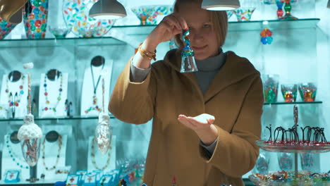 Woman-Choosing-a-Gift-in-Murano-Glass-Shop-in-Venice