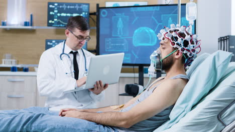 Doctor-using-his-laptop-in-modern-facility-for-brain-analysis