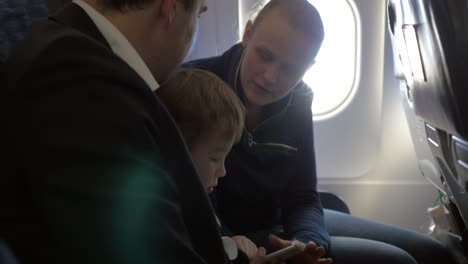 Child-and-young-parents-traveling-by-plane