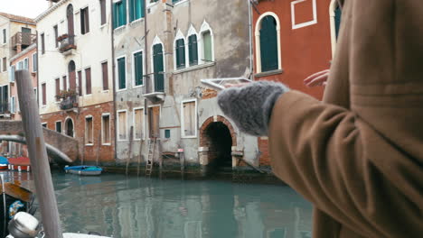 Girl-using-tablet-PC-during-the-walk-in-Venice