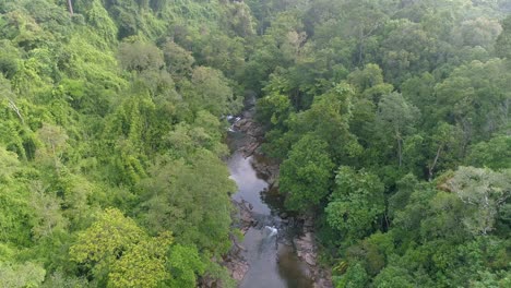 Drone-Soaring-Above-River-Towards-Waterfalls