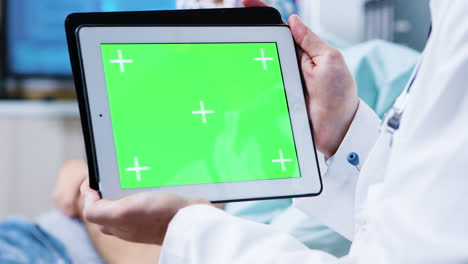 Doctor-holding-tablet-with-green-screen-in-a-clinic-for-brain-research