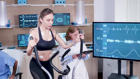 Female-doctor-in-sport-science-testing-the-heart-rate-of-female-athlete