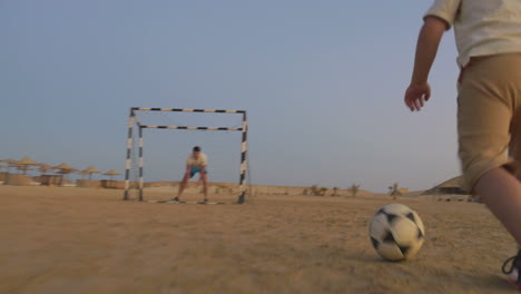 Boy-is-ready-to-make-a-goal-in-this-beach-football
