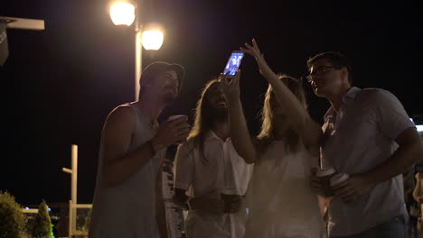 Friends-making-mobile-selfie-in-night-street