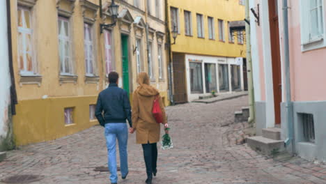 Loving-couple-having-a-walk-in-old-empty-street