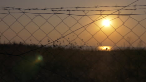 Beautiful-sunset-seen-through-barbed-wire