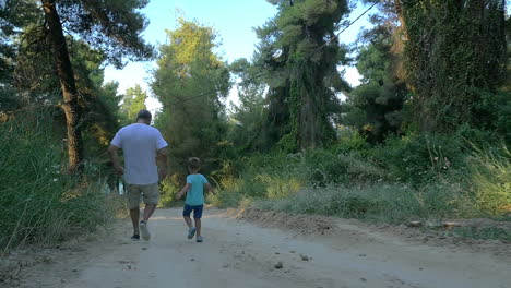 Grandson-and-grandfather-running-in-the-woods