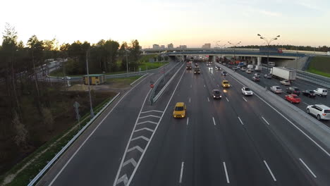 Flying-over-the-city-highway-in-the-evening