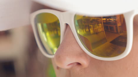Close-up-of-woman-wearing-mirrored-sunglasses
