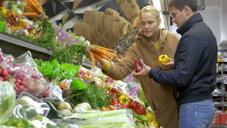 Man-and-woman-buying-fresh-vegetables-in-supermarket