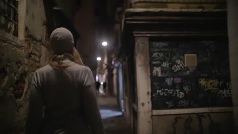 Woman-wandering-in-dark-alleyway-at-night