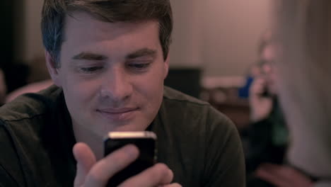 Young-man-using-cell-phone-with-happy-look