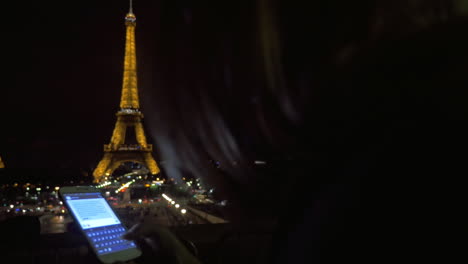 Woman-with-cellphone-in-night-Paris