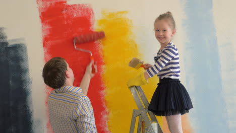 Father-and-daughter-painting-walls-in-bright-colors
